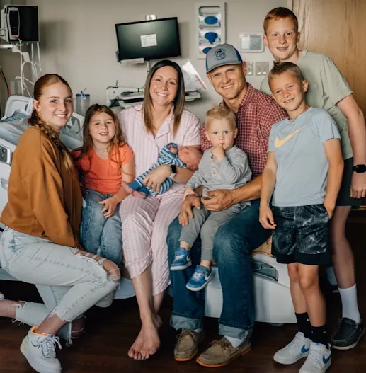 Family of six in hospital room after birth of newest baby