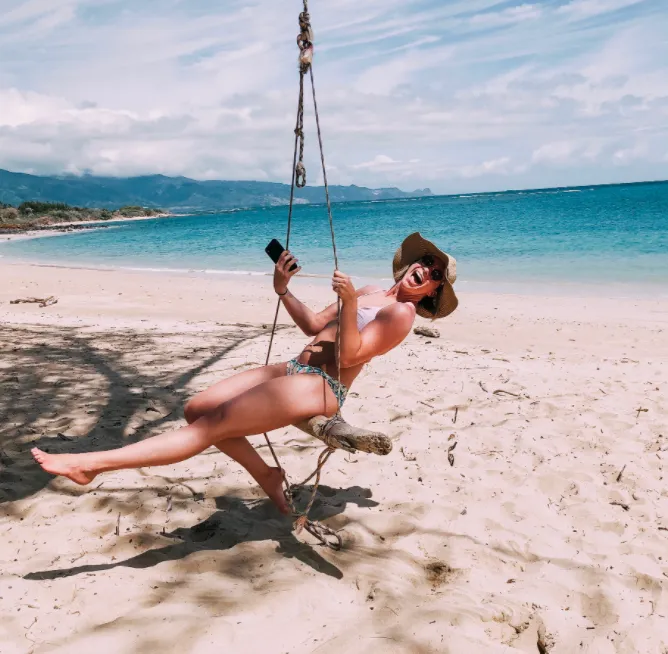 micah on tree swing on the beach